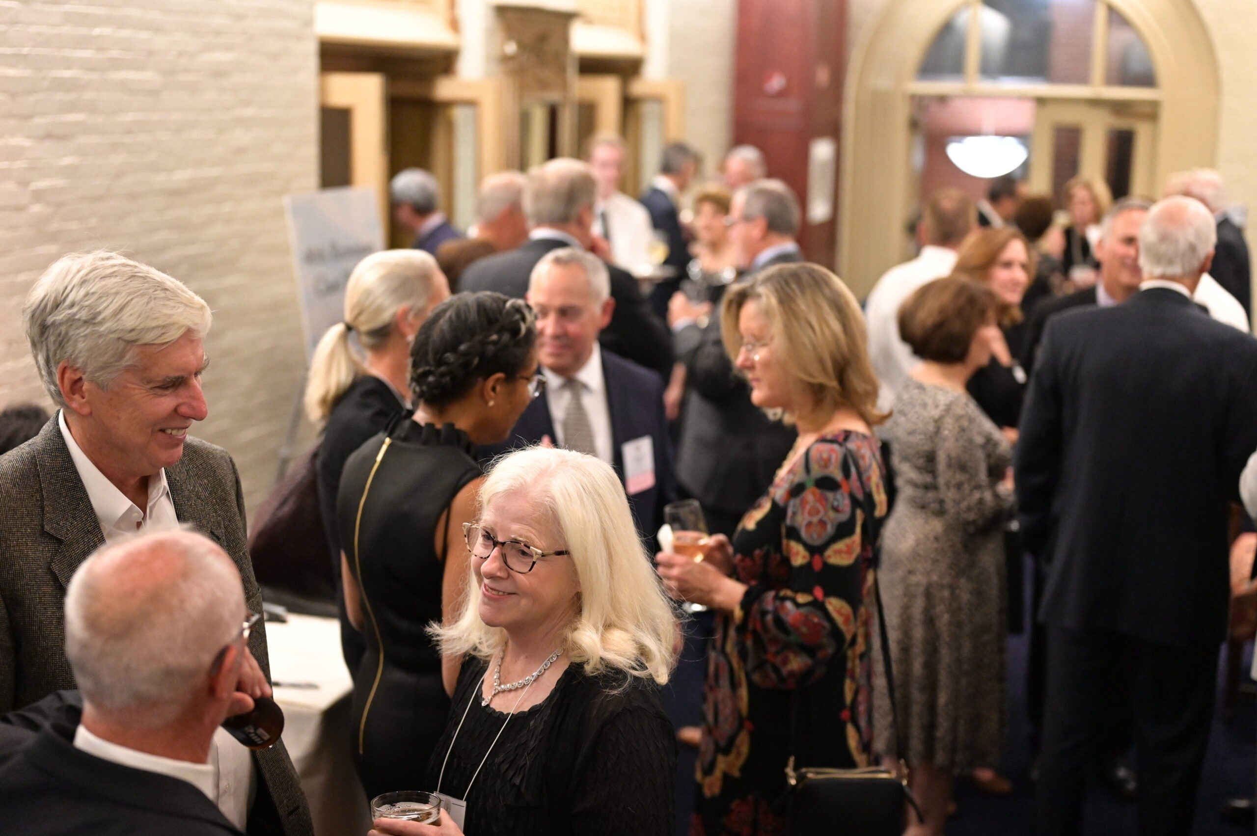 Med Reunion attendees mingle during a reception event